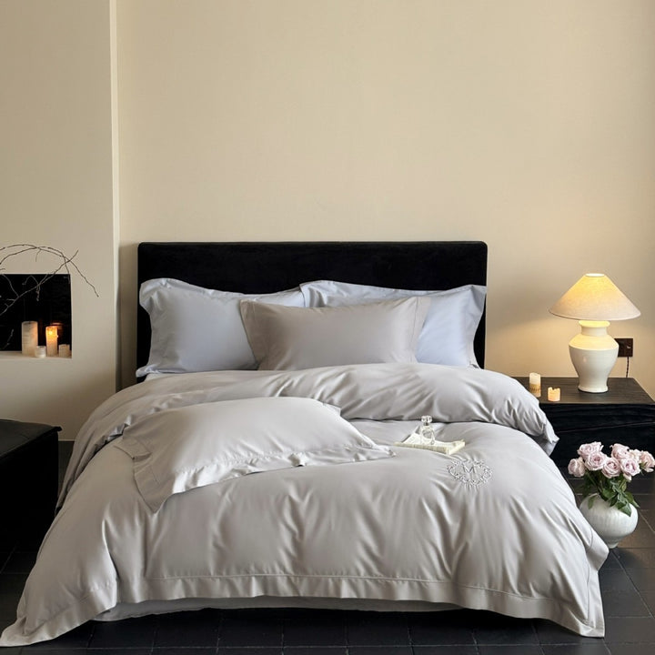Luxurious cotton satin bedding set with monogram embroidery and fine piping
