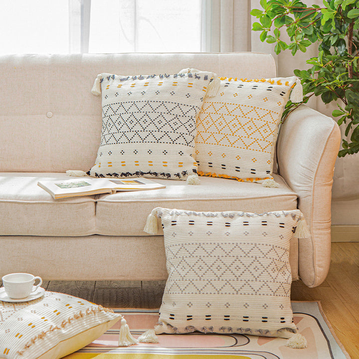 Square decorative cushion cover made of cotton blend with hand-tufted geometric relief and tassels