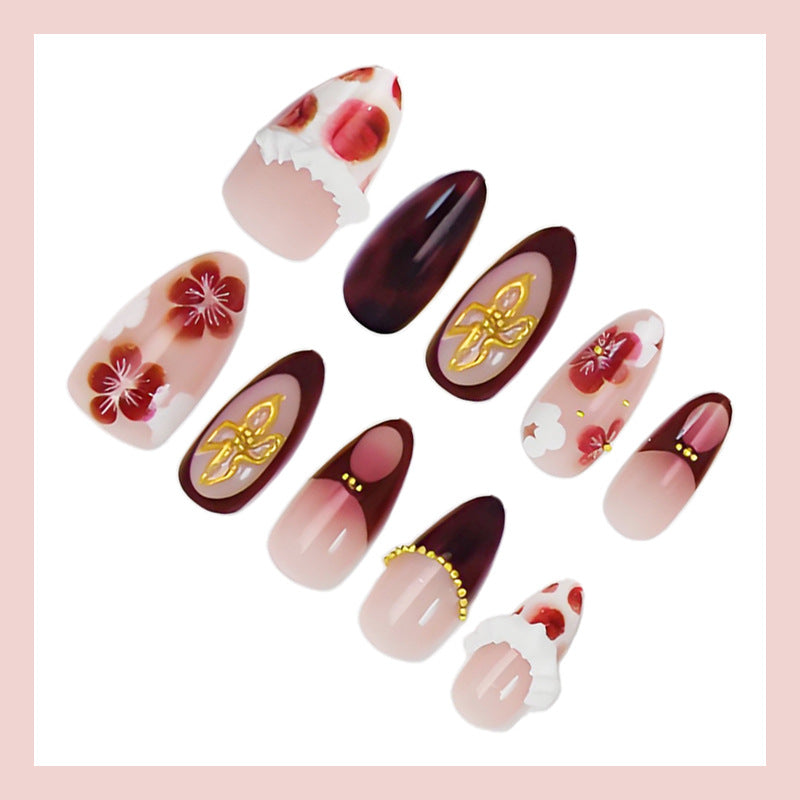 Artificial nail set with luxurious floral designs and glitter accents Stornfield