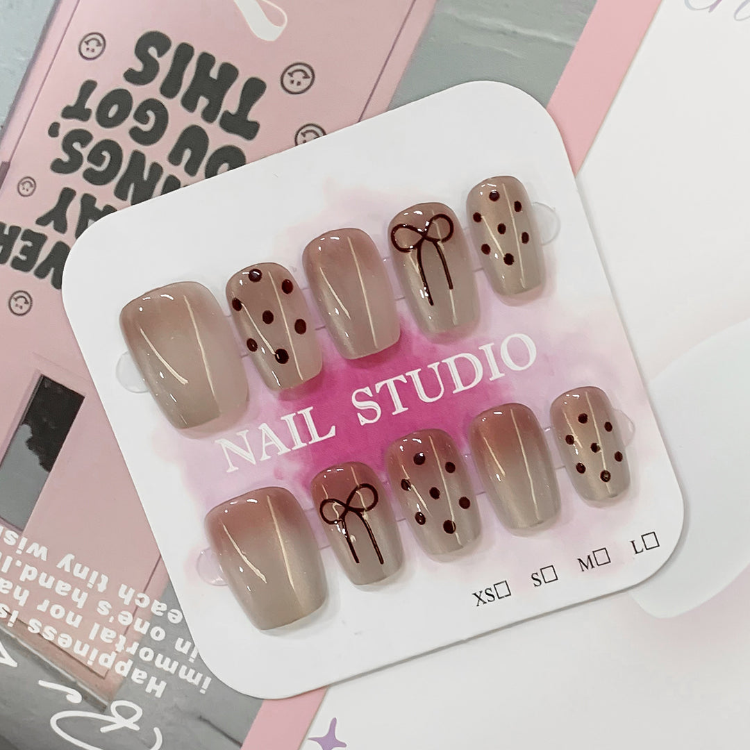 Artificial nail tips with bow and dot patterns Stornfield