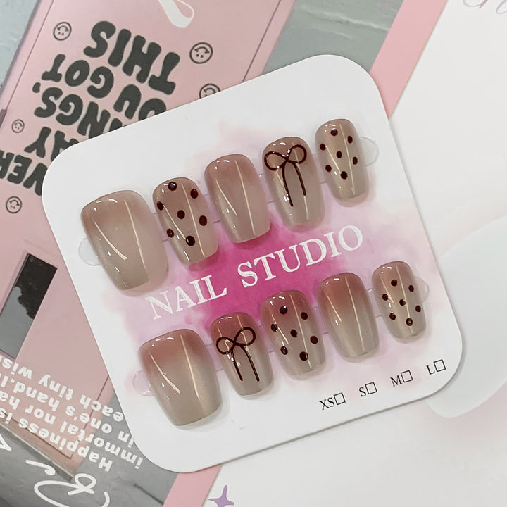 Artificial nail tips with bow and dot patterns Stornfield
