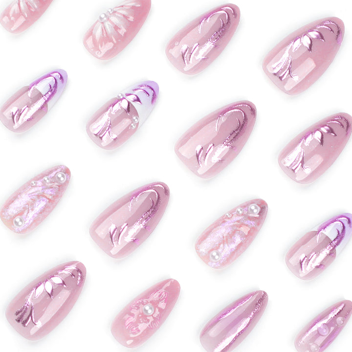 Artificial nail extensions with delicate floral designs and glitter accents Stornfield