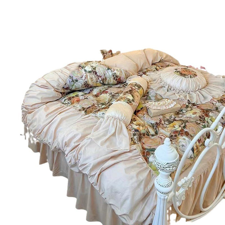 Romantic bedding set with ruffles, quilted bedspread and decorative cushion