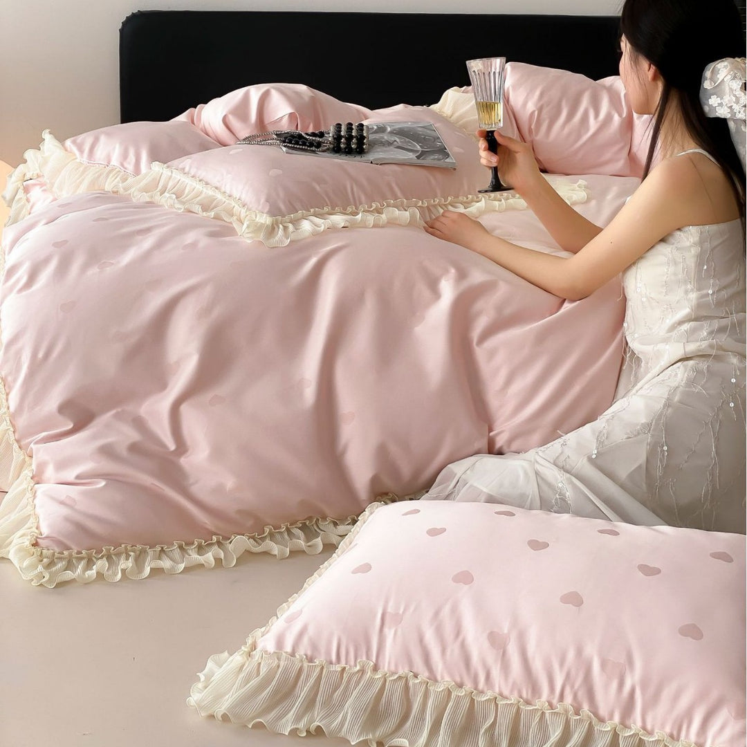 Elegant reversible bedding with romantic ruffle trim and subtle polka dot relief
