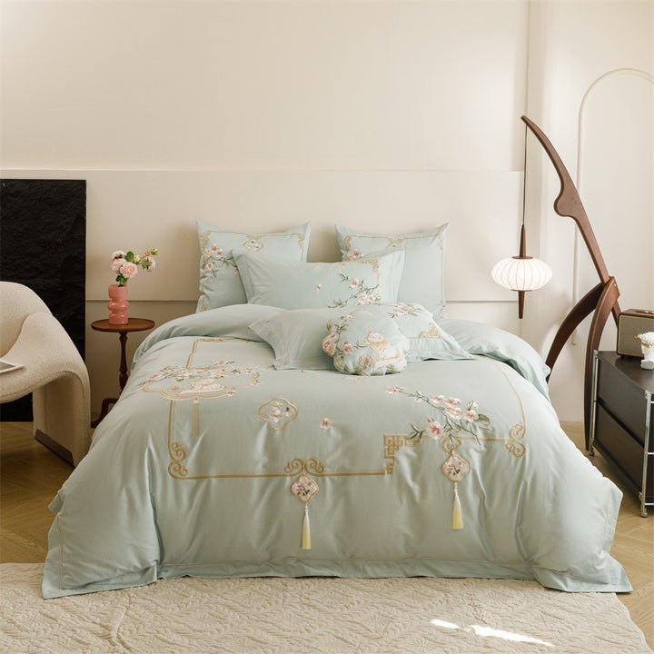 Luxurious cotton satin bedding set with fine embroidery, floral motifs, and decorative pillows