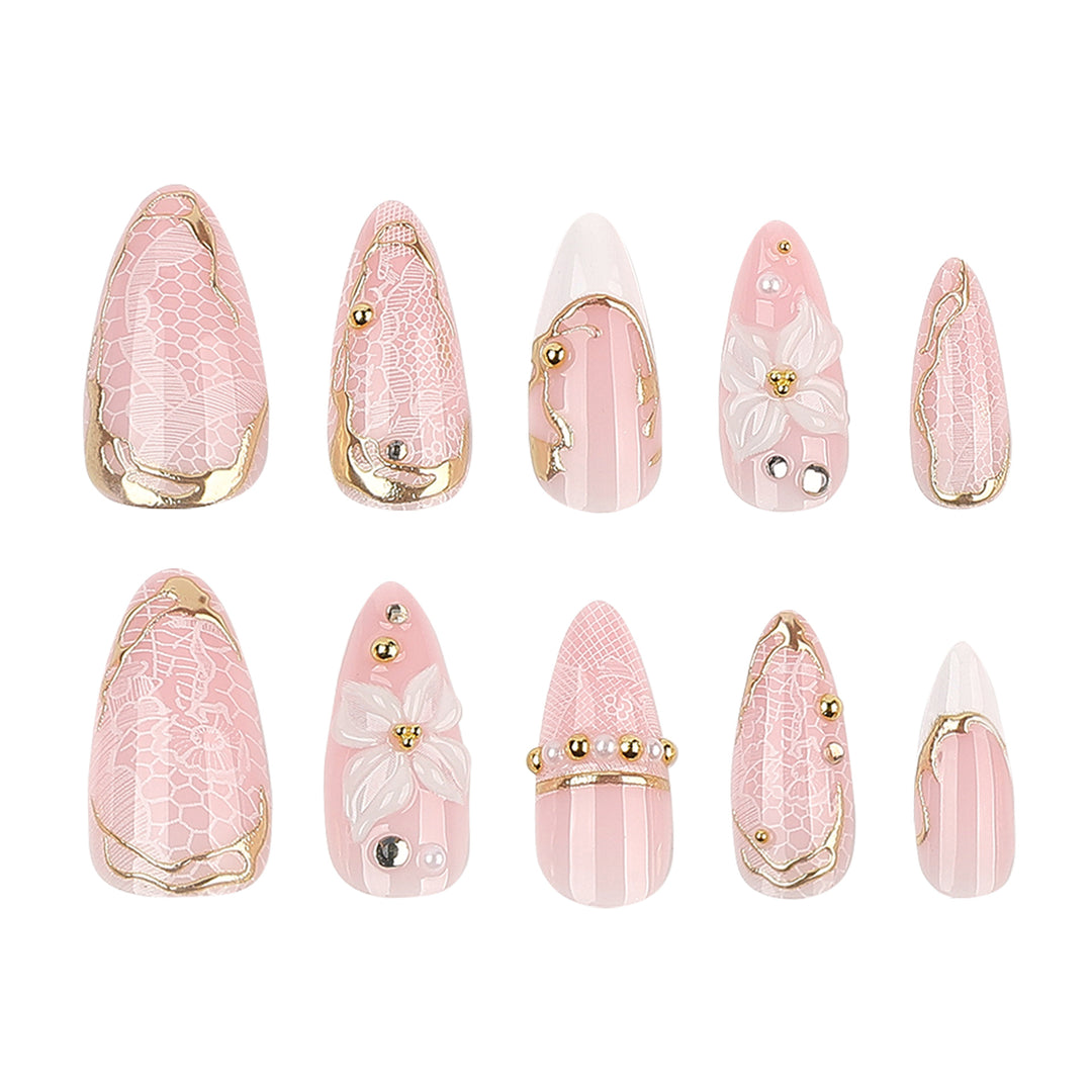 Artful nail extensions with delicate flower and gold embellishments Stornfield