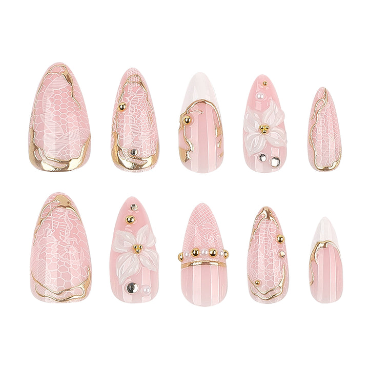 Artful nail extensions with delicate flower and gold embellishments Stornfield