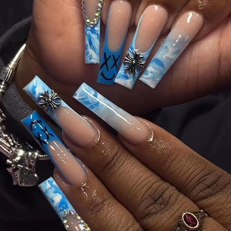 Artistic acrylic nails with marbled design and unique embellishments Stornfield
