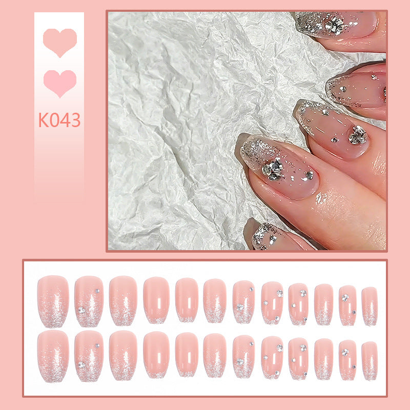 Glamorous artificial nails with glitter and rhinestone embellishments Stornfield