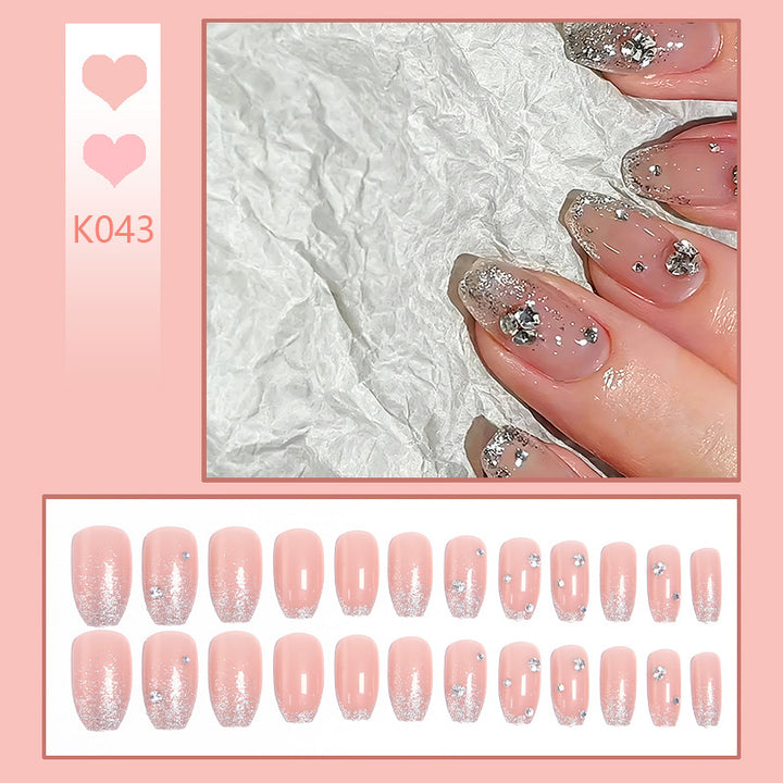 Glamorous artificial nails with glitter and rhinestone embellishments Stornfield