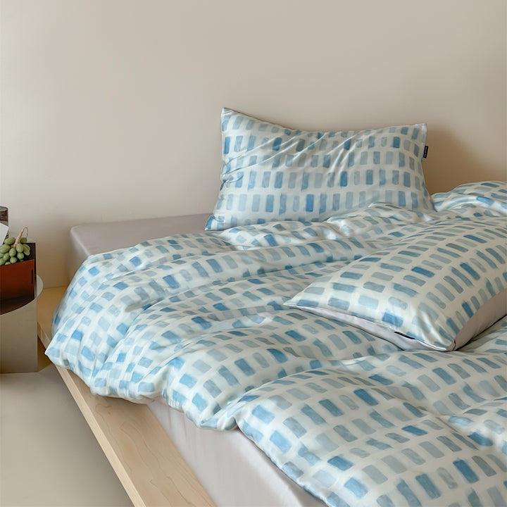 Luxurious satin bedding set with floral watercolor print, ruffled edges and reversible function