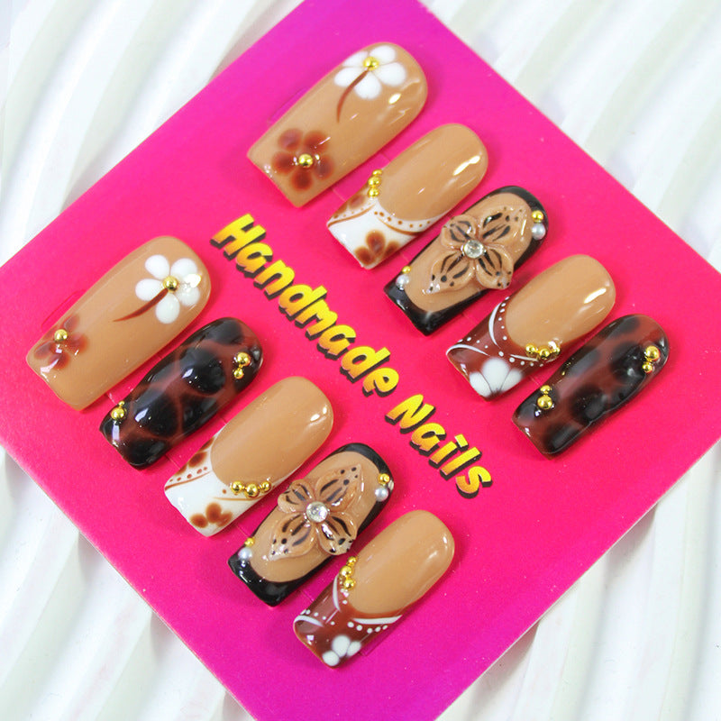 Acrylic nail set with elegant handcrafted designs and decorative accents Stornfield
