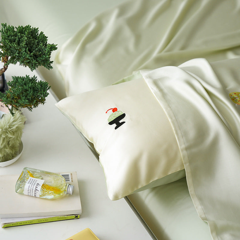 Reversible cotton satin bedding set with fitted sheet and subtle embroidery appliqués