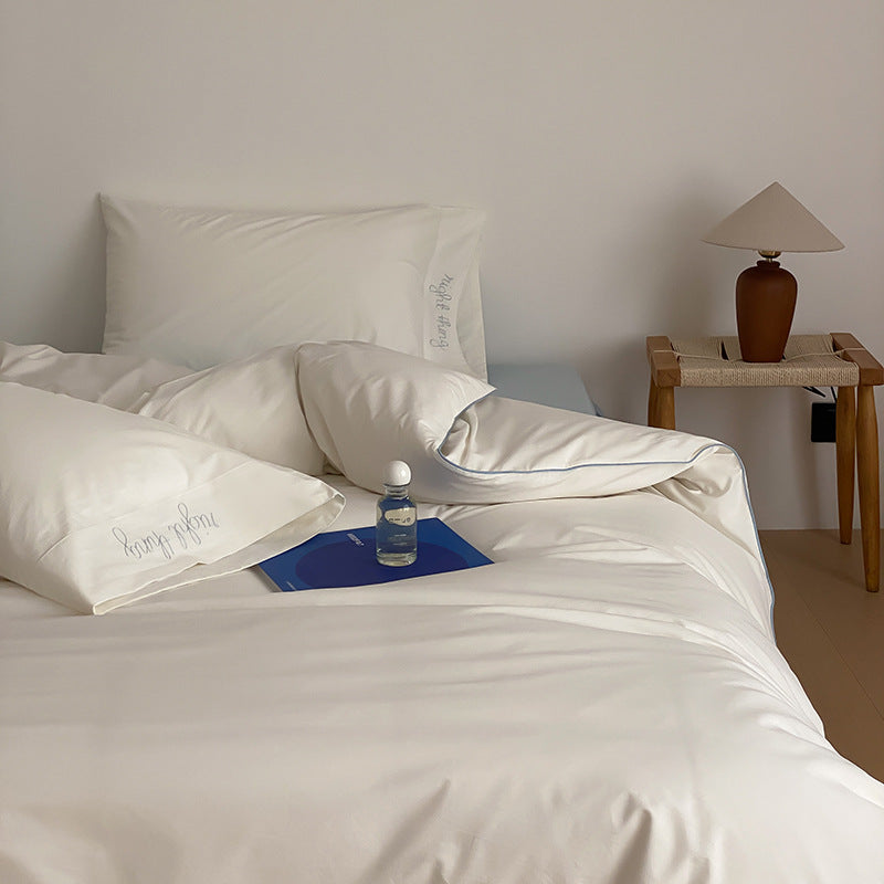 Cotton satin bed linen set with contrasting piping and subtle brand embroidery