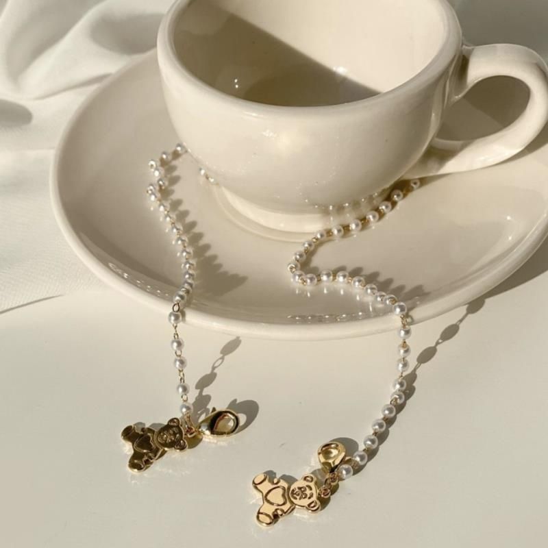 Playful pearl necklace with gold pendants Stornfield