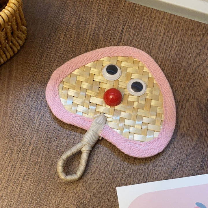 Handcrafted fan with playful face motif Stornfield
