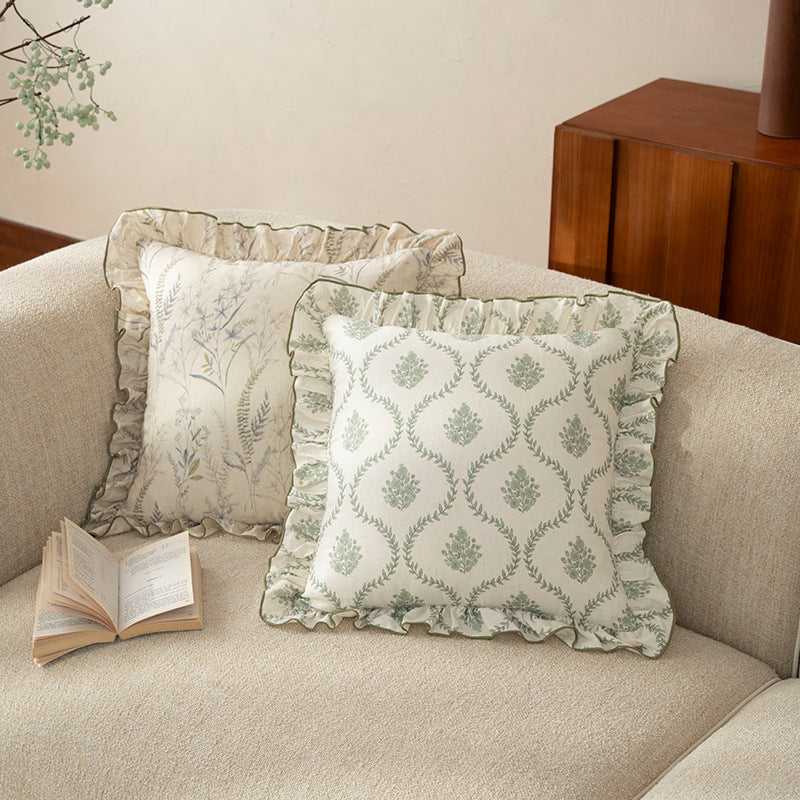 Decorative pillow with ruffles and floral linen cover