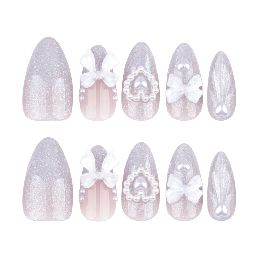 Artful nail decoration with pearl and bow accents Stornfield