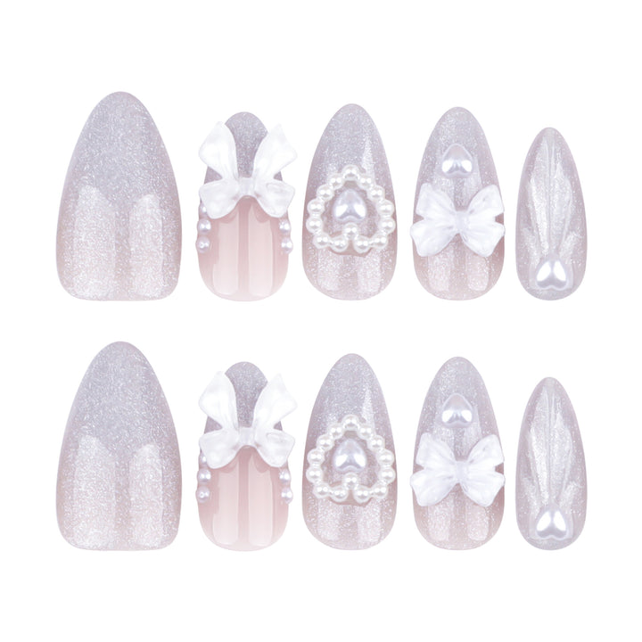 Artful nail decoration with pearl and bow accents Stornfield