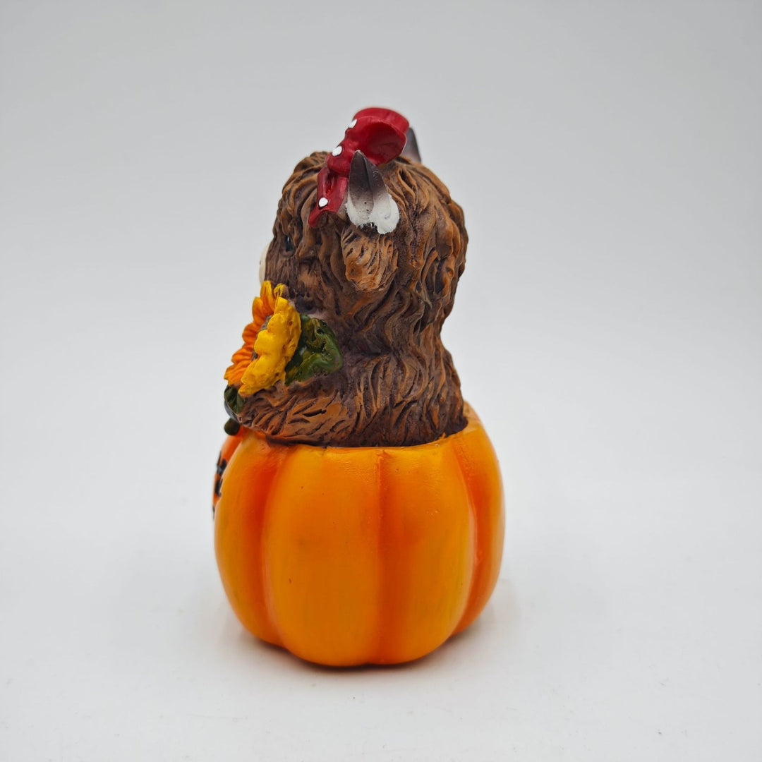 Funny decorative figure of a Highland cow in pumpkin costume Stornfield