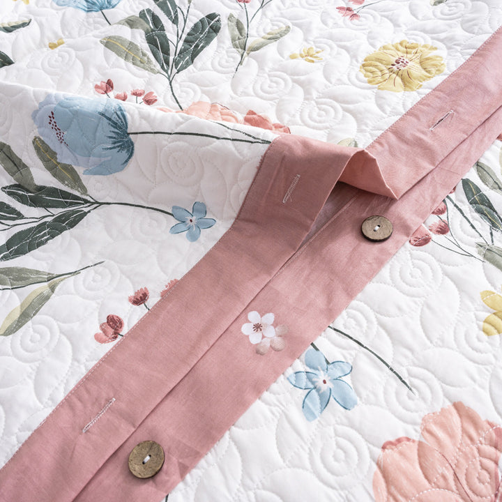 Quilted bedspread and bedding set with floral print, reversible function and decorative button placket
