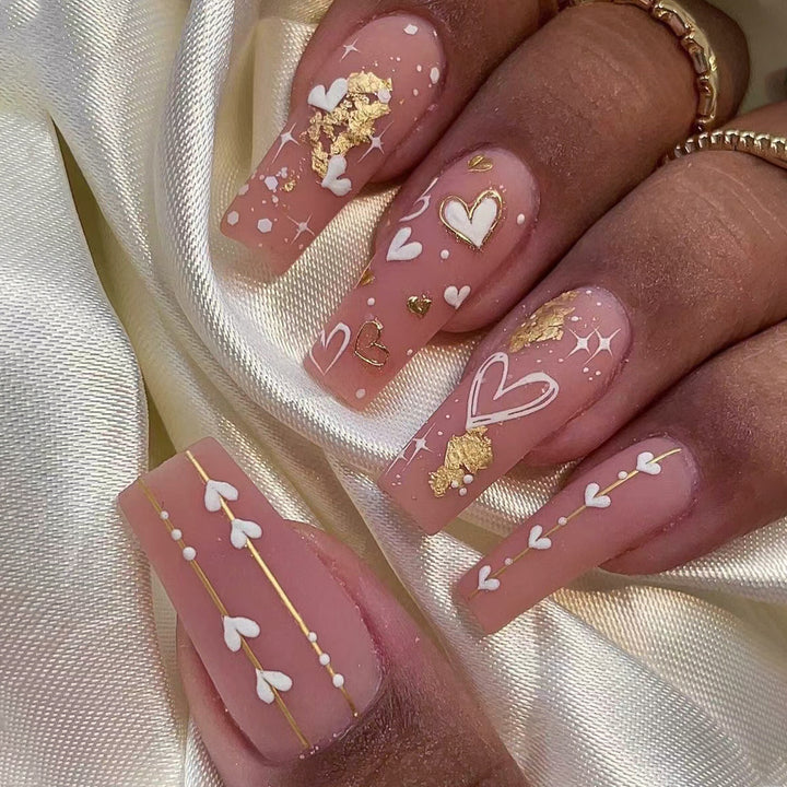 Artificial nail art with heart and glitter designs Stornfield