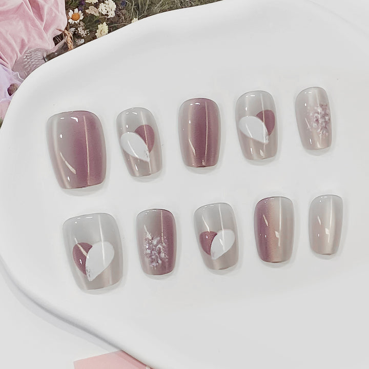 Artistic acrylic nails with heart-shaped accents Stornfield