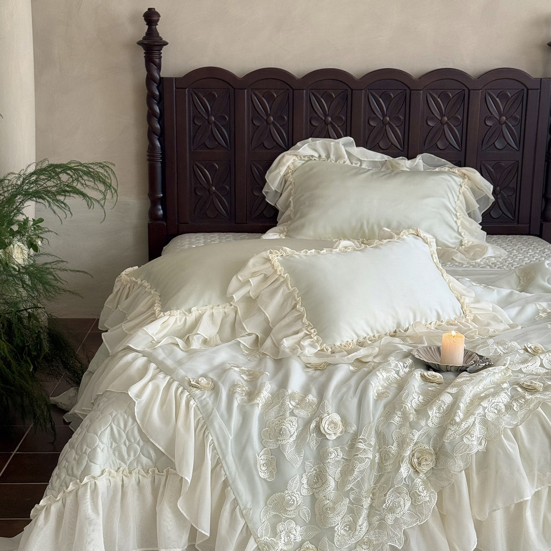 Romantic bedding set with quilted bedspread, ruffled pillow and floral embroidery