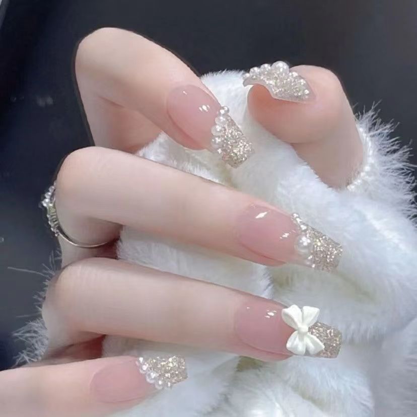 Glamorous artificial nails with delicate flower and glitter effects Stornfield