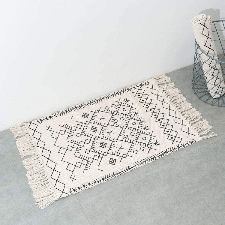 Woven cotton rug runner with flat weave structure, graphic diamond ethnic pattern and fringes