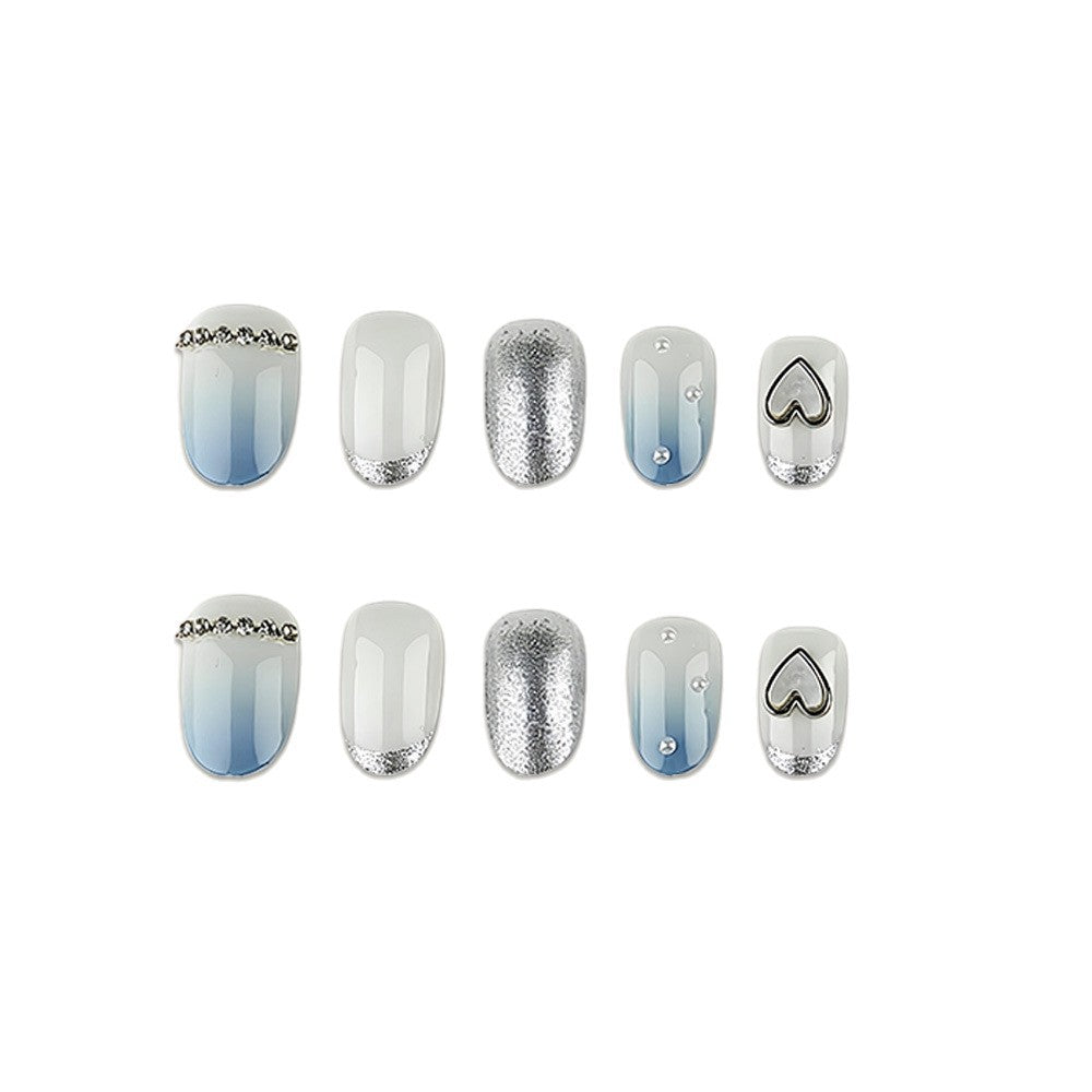 Glamorous artificial nails with heart design and pearl details Stornfield