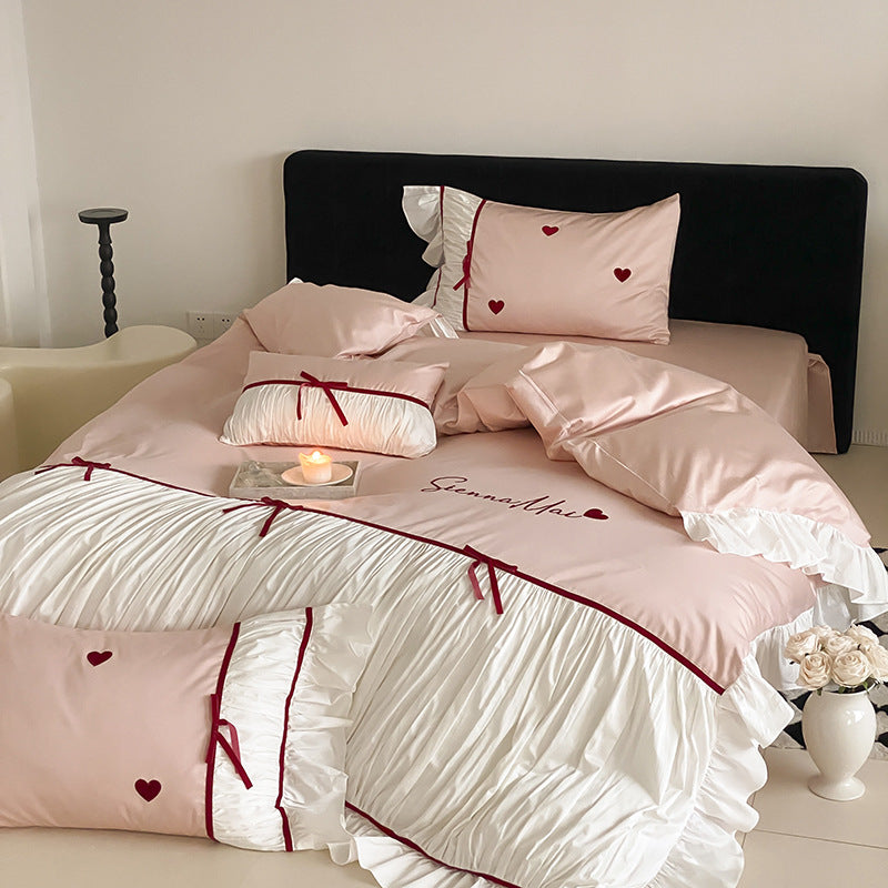 Romantic bedding set with ruffles, heart embroidery and luxurious satin look