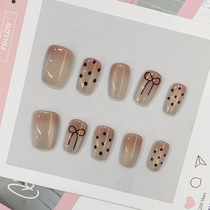 Artificial nail tips with bow and dot patterns Stornfield