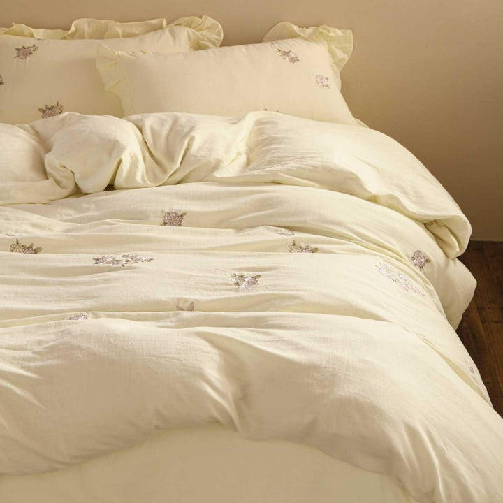 Breathable cotton bedding set with delicate flower embroidery and tie ribbon pillow