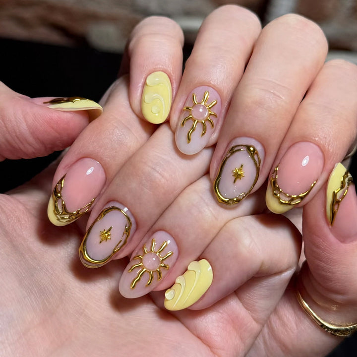 Acrylic nail set with elegant gold embellishments and creative designs Stornfield