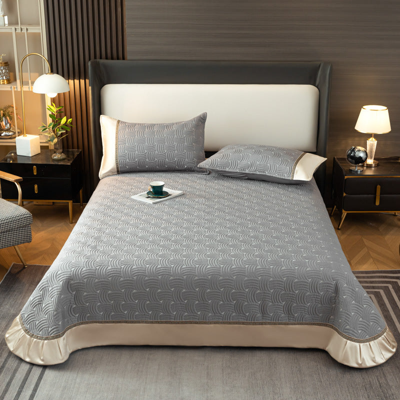 Quilted bedspread set with satin ruffle and geometric wave relief