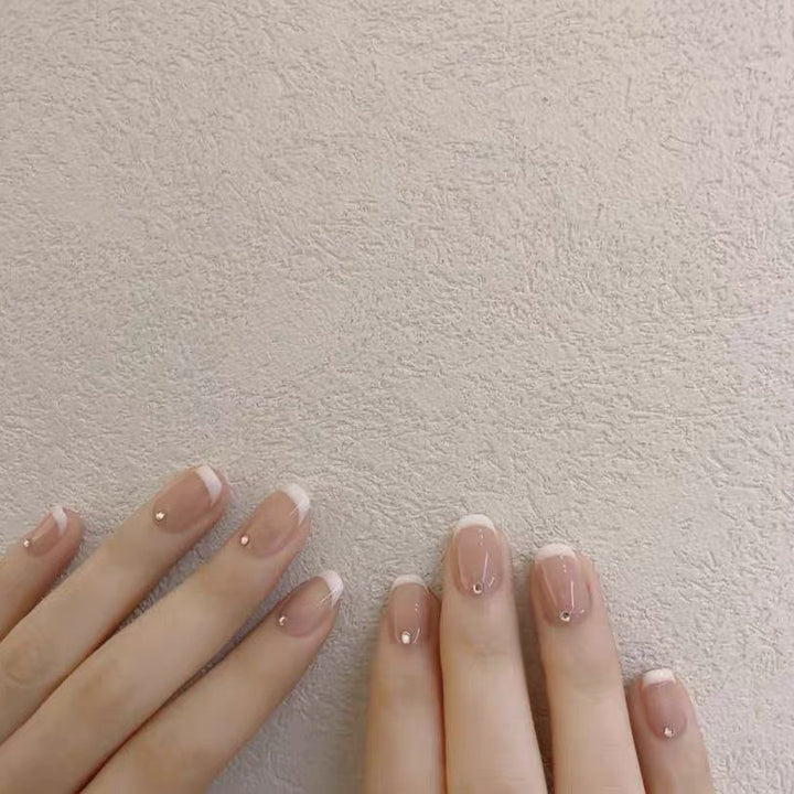 Artificial nails with elegant French tip and rhinestone accents Stornfield
