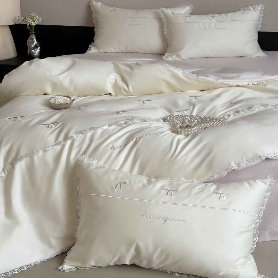Elegant bedding set made of silky fine satin with embroidered bows and lace trim