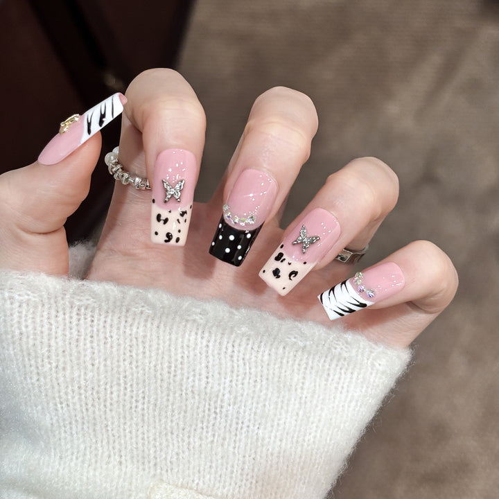 Artistic Press-On Nail Enhancements with Pattern and Gem Accents