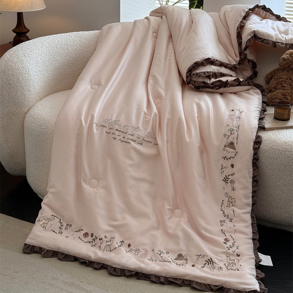 Quilted reversible duvet cover with floral embroidery and ruffled hem