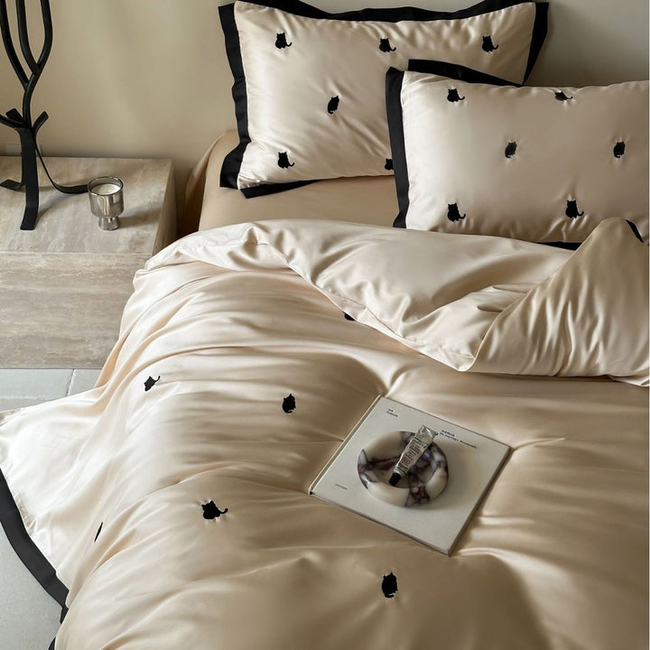 Elegant satin bed set with fine cherry embroidery and contrasting piping
