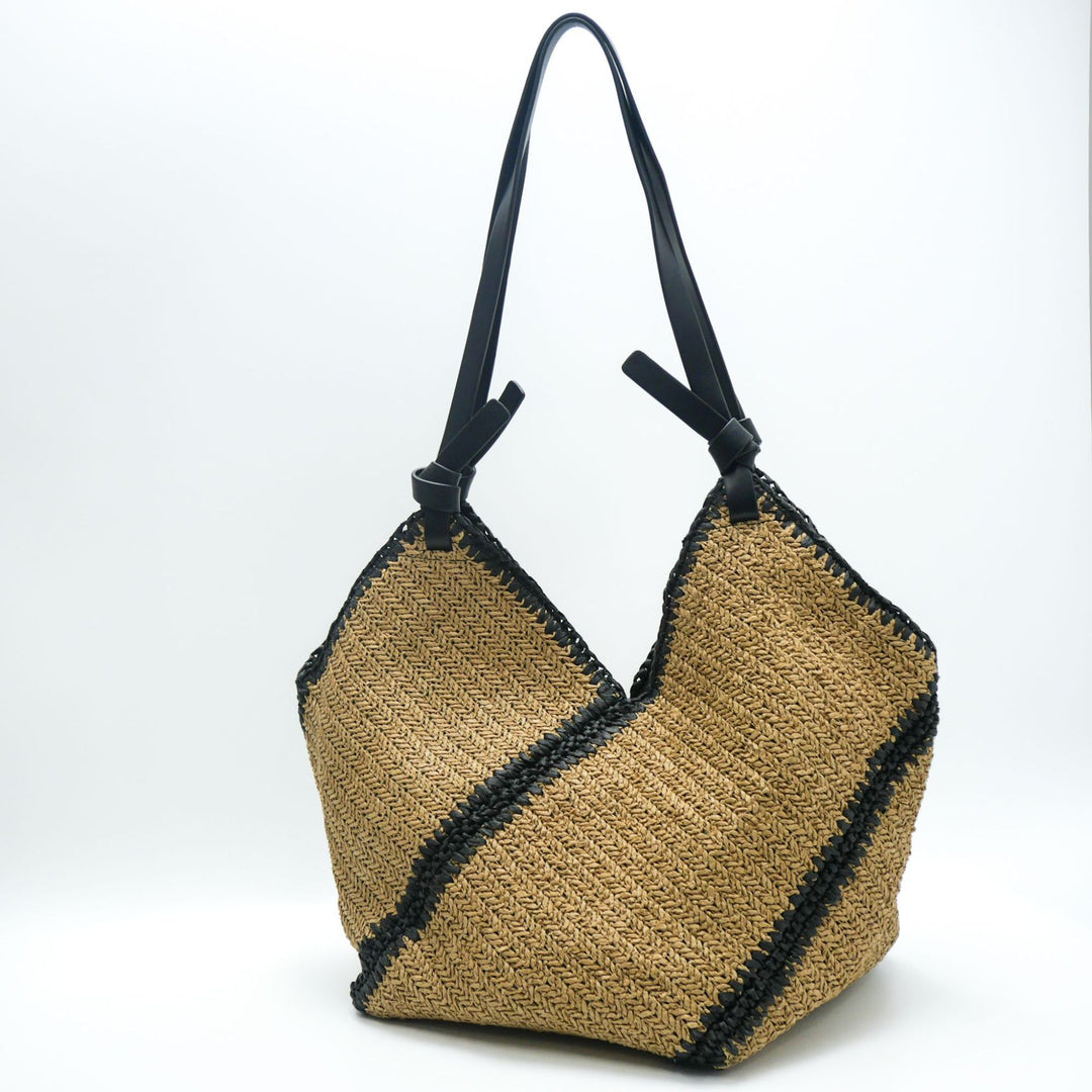 Fashionable beach bag made of woven natural material with leather handles Stornfield