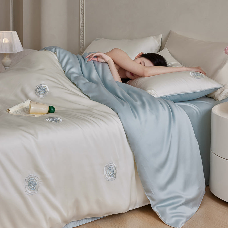 Luxurious satin bedding set with floral embroidered rose details and reversible function
