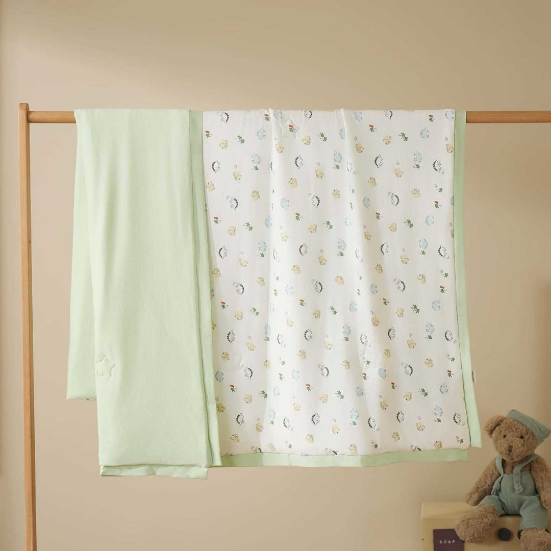 Double-layer baby crawling blanket made of cotton jersey with light padding and delicate all-over animal print