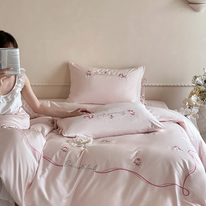 Elegant satin bedding with delicate rose embroidery and tie band detail