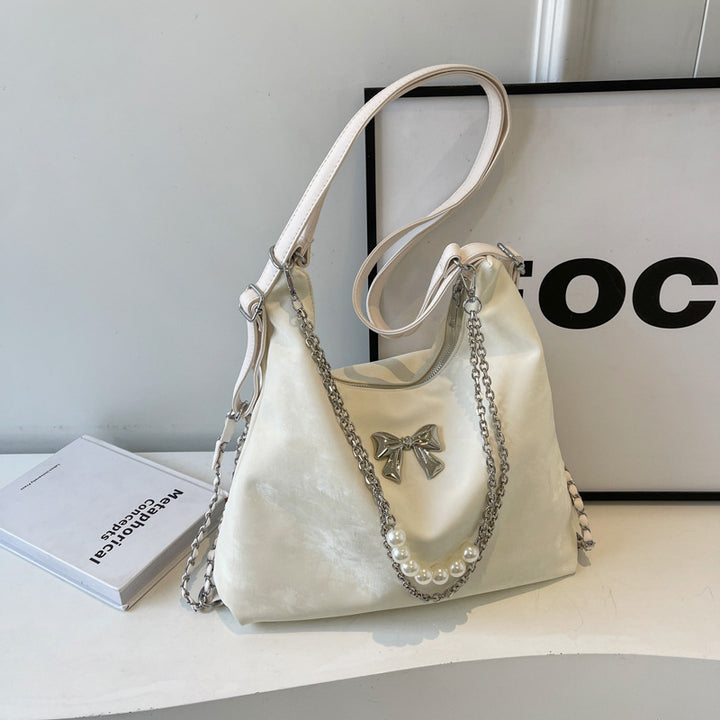 Fashionable handbag with unique pendant and chain accents Stornfield