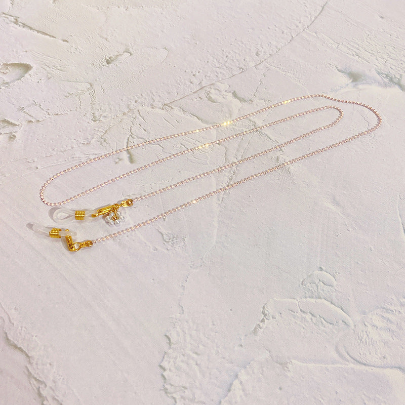 Eyewear chain with pearls and gold pendants Stornfield