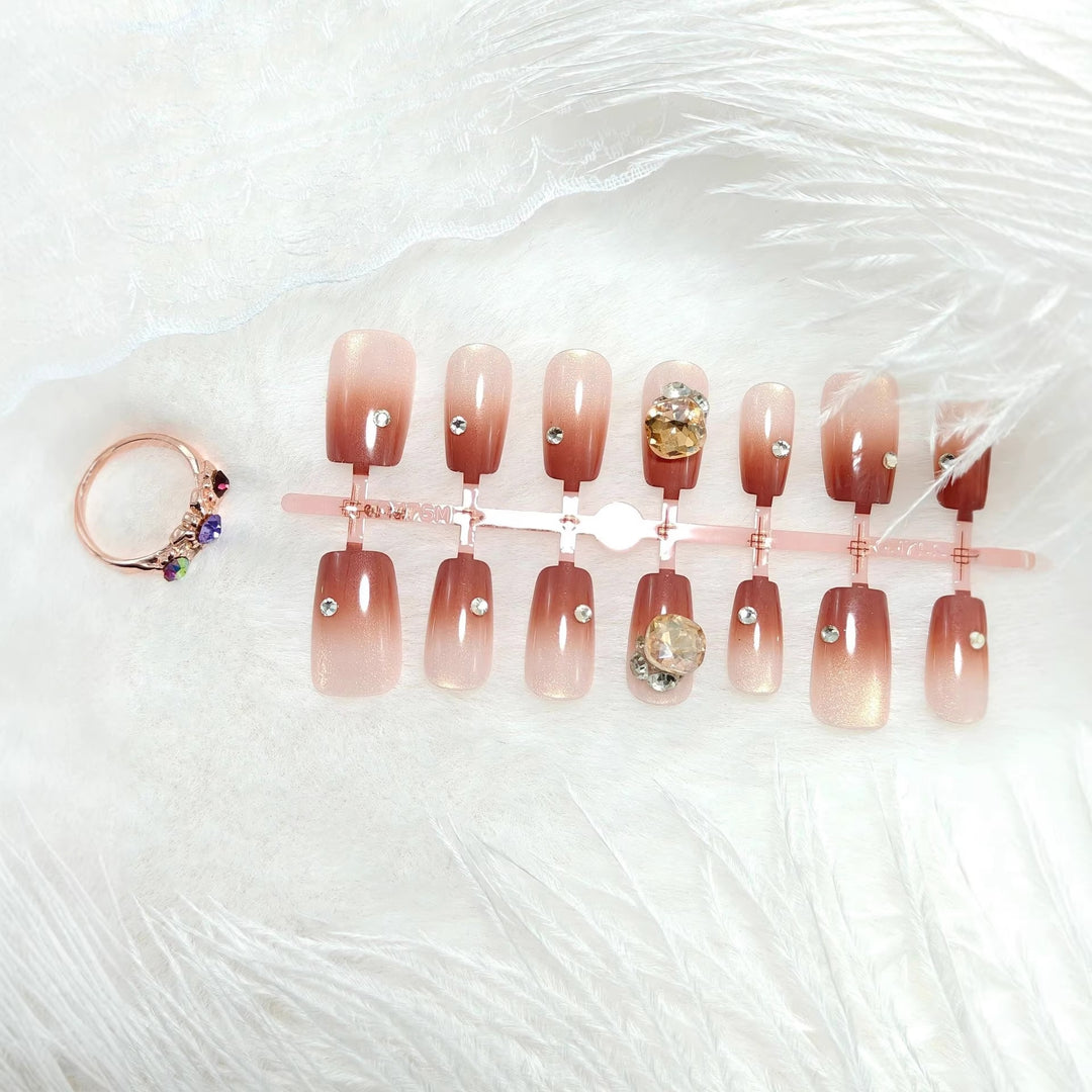Artificials nails in elegant ombre style with rhinestone embellished applications Stornfield