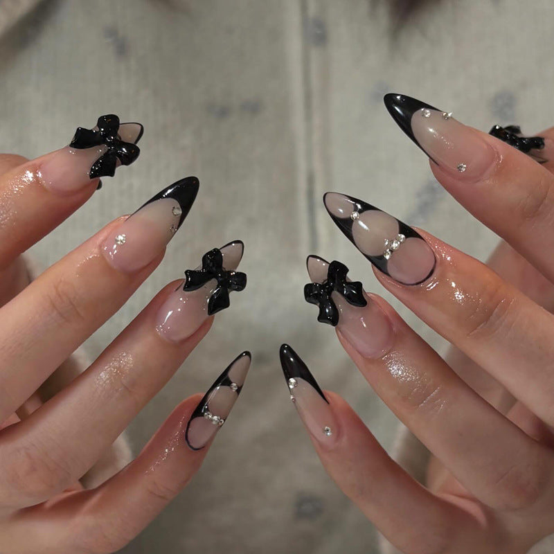 Acrylic nail set with shimmering accents and elegant bows Stornfield
