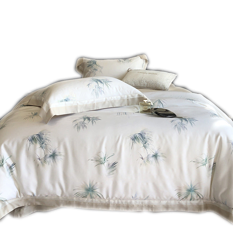 Luxurious cotton satin bedding set with delicate leaf print, contrasting hem and fine piping